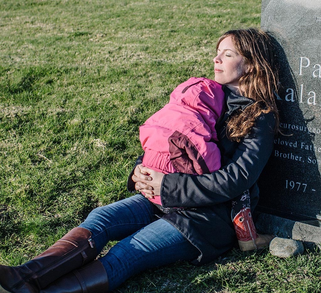 Lucy Kalanithi with her daughter at Paul Kalanithi's gravesite.