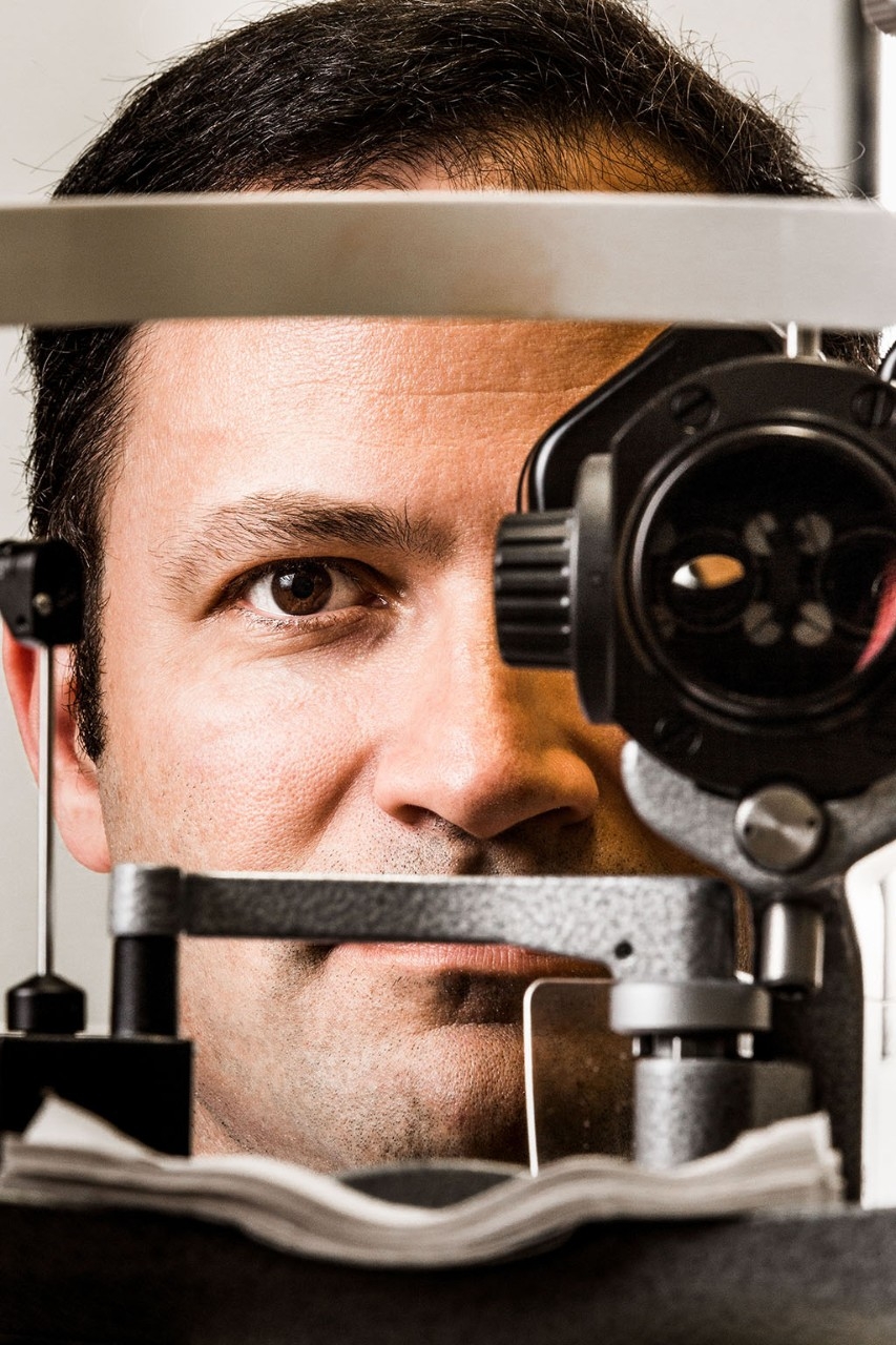 Man looking through an opthalmascope