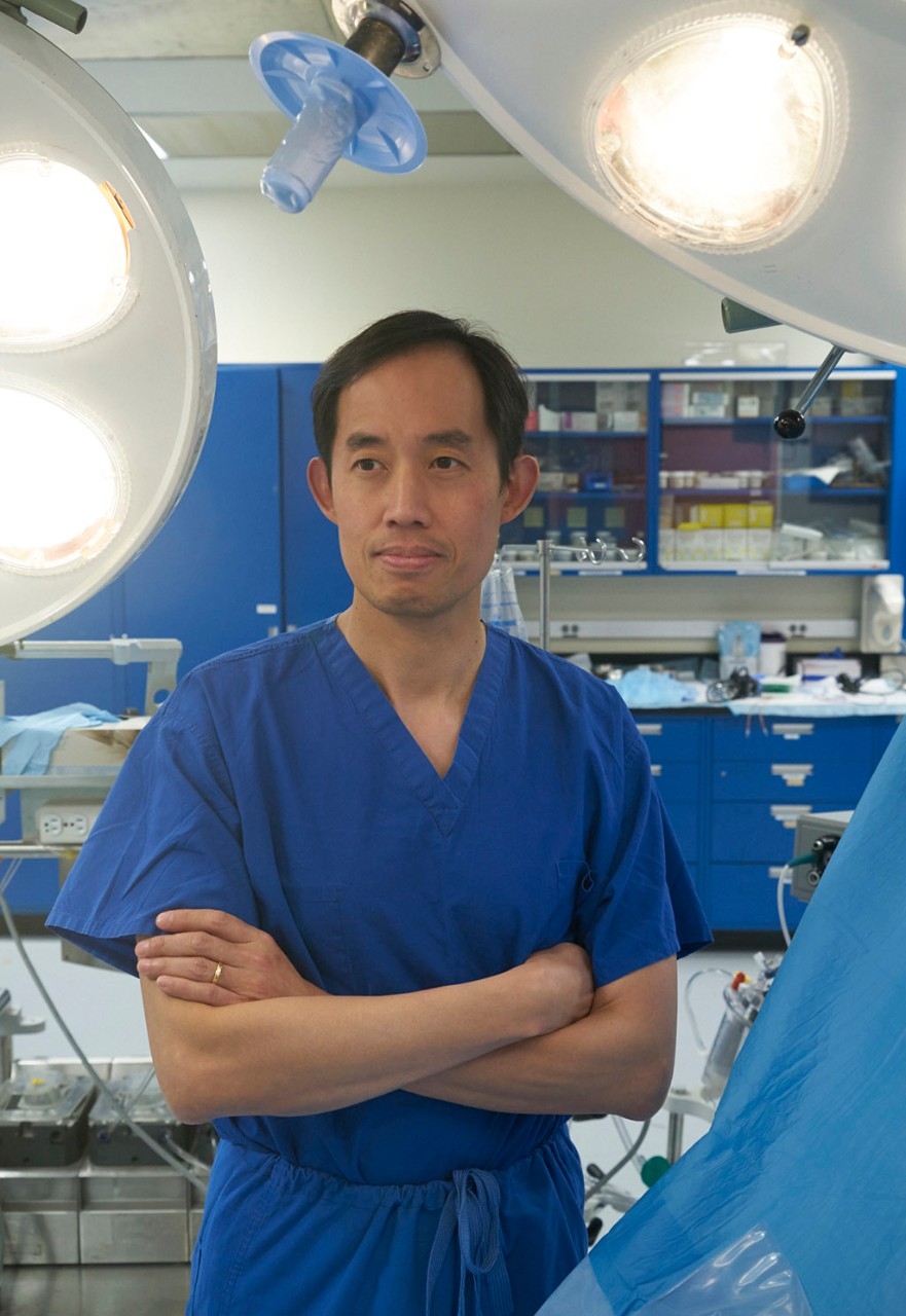Joseph Woo, MD standing in operating room