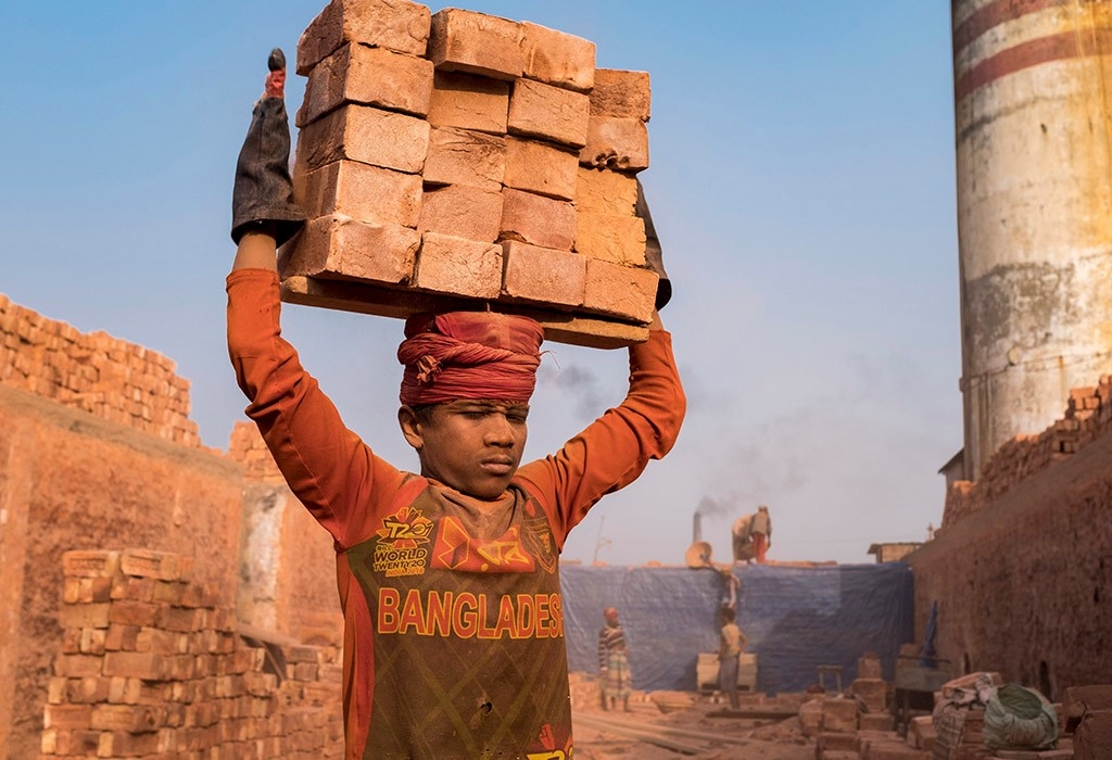 A worker in Bangladesh carried newly fired bricks