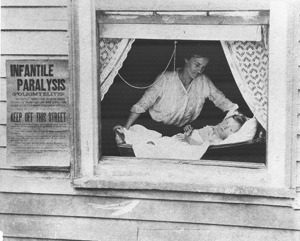 Photo of an isolated child in the window during the 1916 polio epidemic.