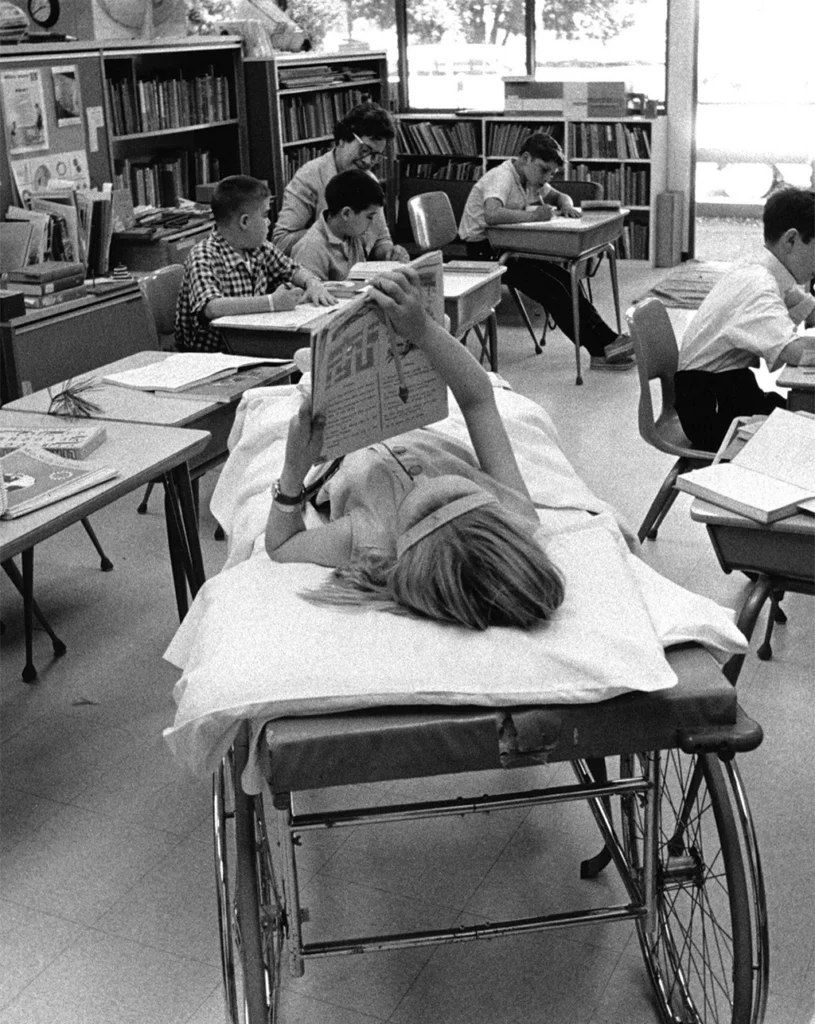 1960 photo of children and a teacher studying at the Stanford Hospital School.