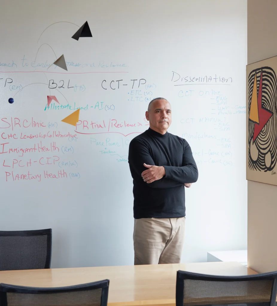 Photo of Victor Carrión, MD, in a meeting room on the Stanford University campus.