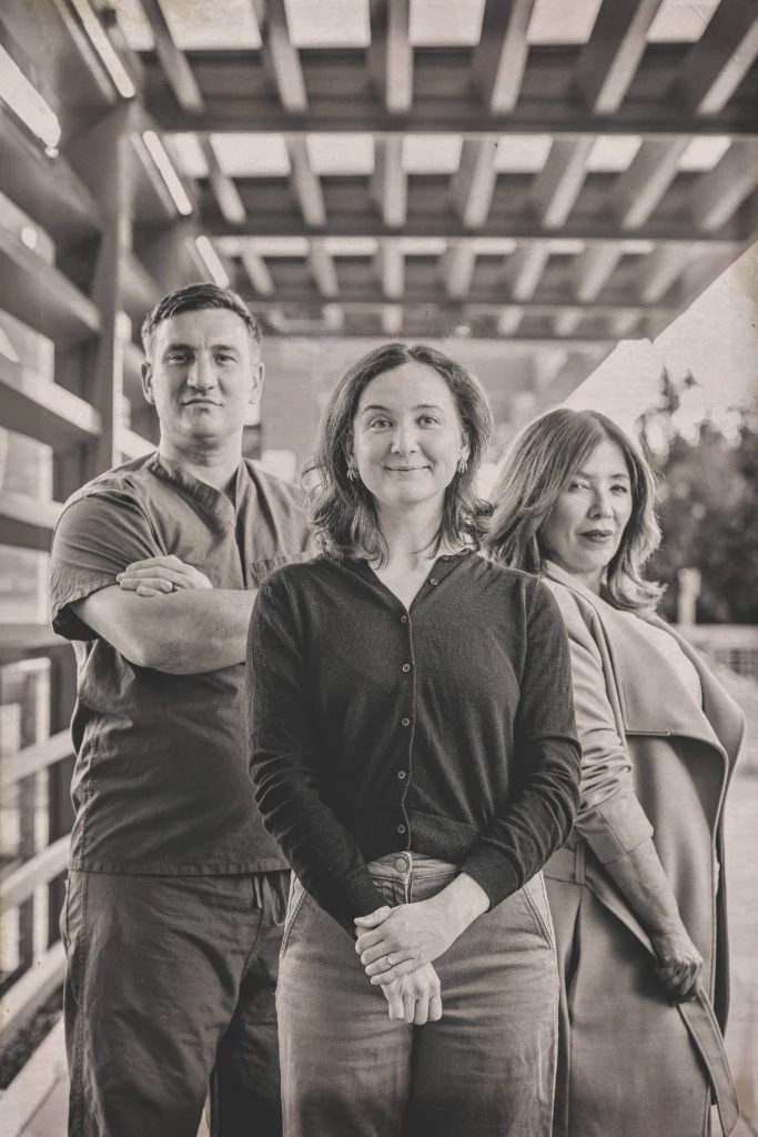 Photo of the team of colorectal surgeon Aaron Dawes, at left, clinical research coordinator Eleanor Catherine Irvine Brown, center, and community health worker Patricia Castañeda