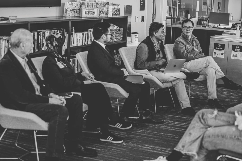 Photo of Bryant Lin with a group of people with  various faith backgrounds  who were gathered to discuss spirituality.