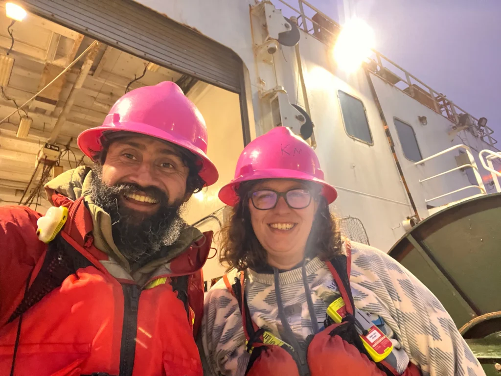 Photo of Manu Prakash, left, and Hannah Rosenblatt, PhD, pictured on the U.S. Navy research vessel Kilo Moana.