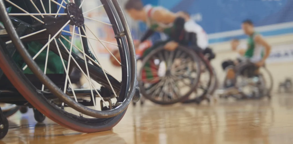 A group of wheelchair athletes playing basketball
