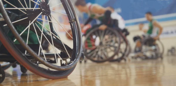 A group of wheelchair athletes playing basketball