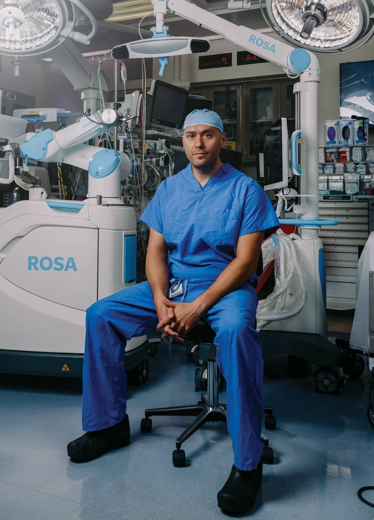 Jason Lipof, MD, a clinical assistant professor of orthopaedic surgery, sitting in the surgical suite.