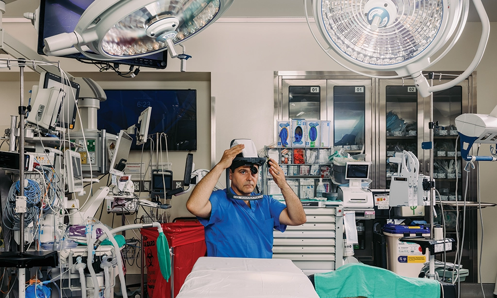 Photo of orthopaedic surgeon Derek Amanatullah, MD, PhD, in the surgical suite at Stanford Hospital preparing for surgery.