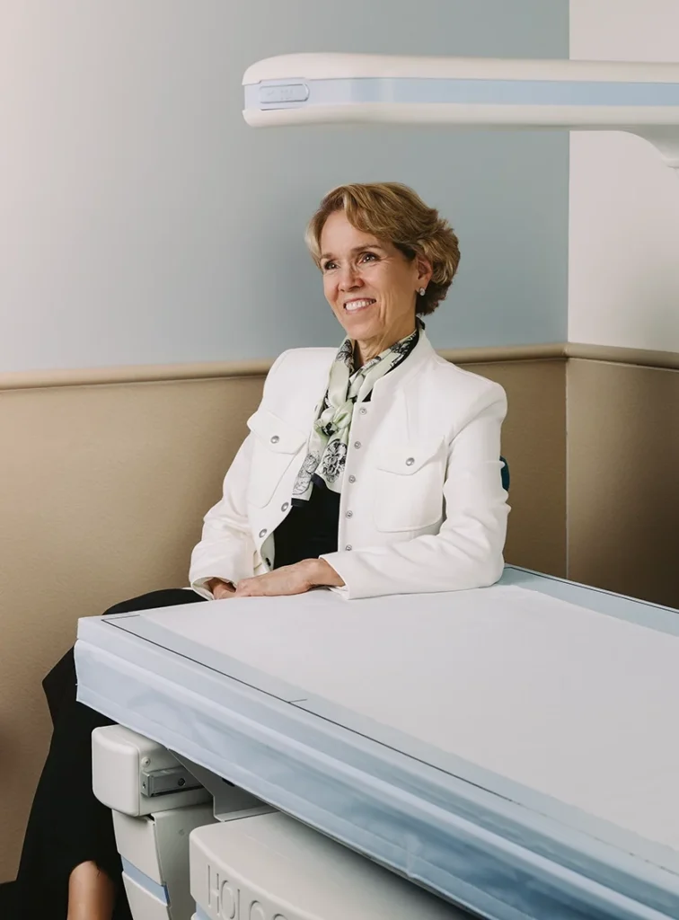 Photo of Mary Leonard, chief of pediatrics, sitting at a table.