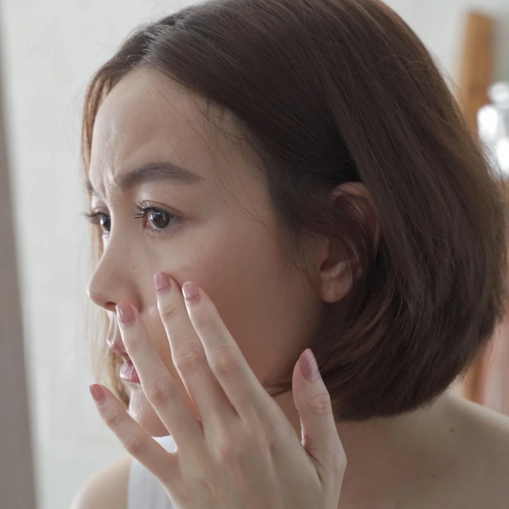 Photo of a woman touching her face